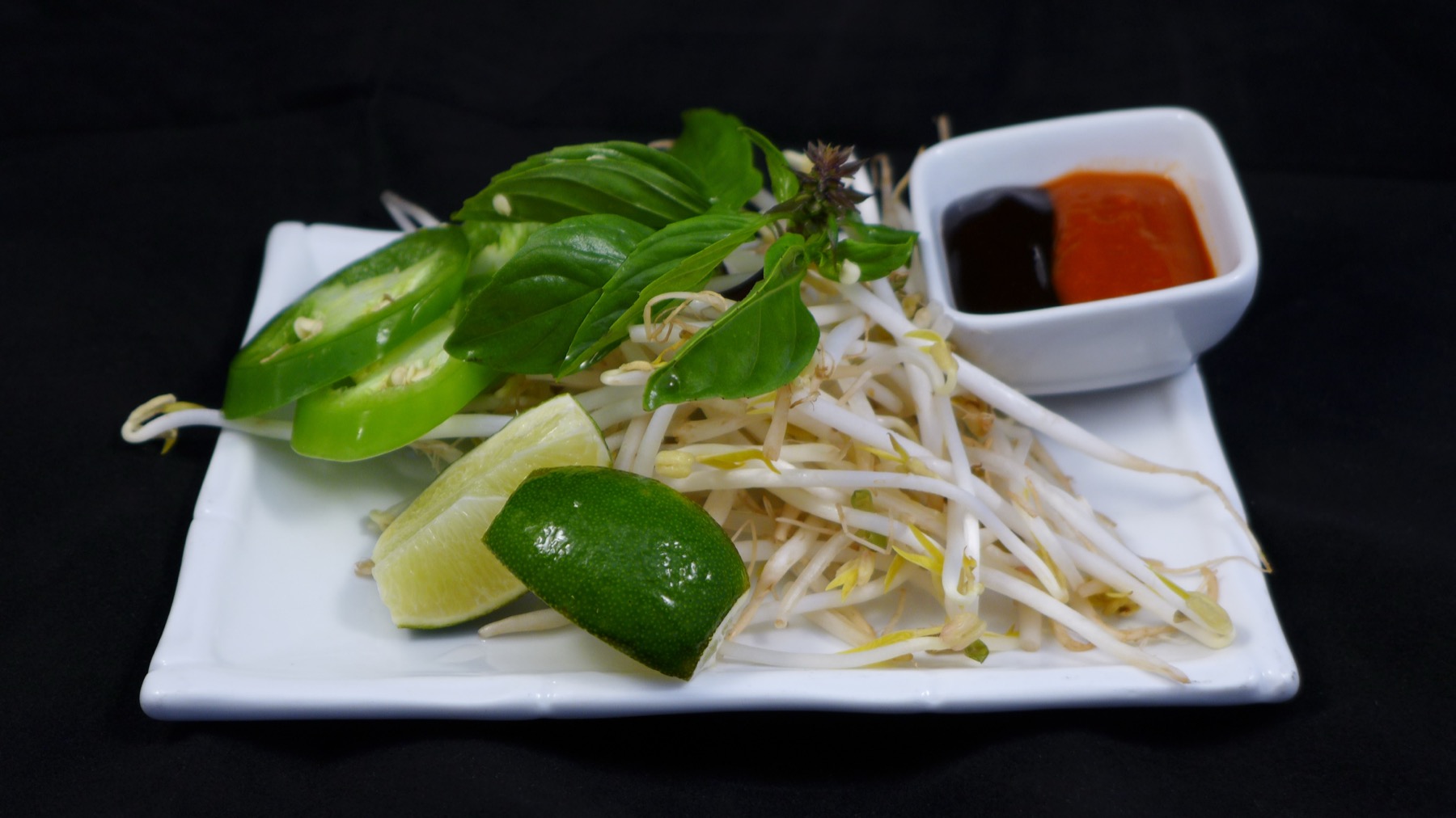 Fresh pho herb plate with basil, bean sprouts and lime